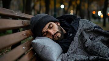 A man sleeping on a bench in the park photo