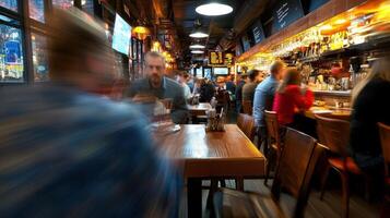 A blurry image of people sitting at tables in a bar photo