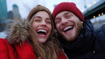 A man and woman are smiling while taking a selfie photo