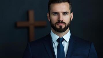 A man in a suit and tie standing in front of a cross photo