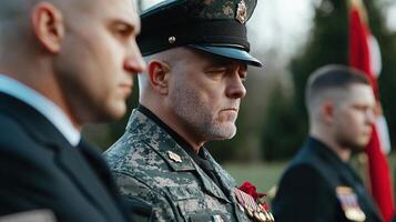 A man in a military uniform is standing with two other men photo