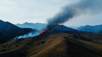 A large plume of smoke is coming out of the mountain photo