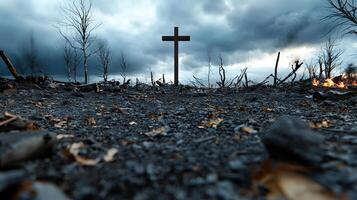 A cross is standing in a field of rubble and debris photo