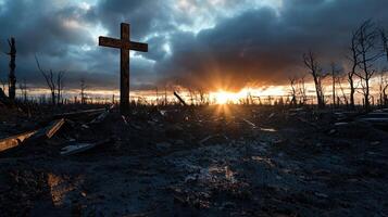 A cross is standing in a field of mud and debris photo