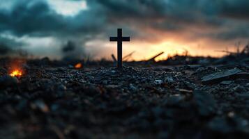 A cross is standing in the middle of a rocky field photo