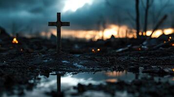 A cross is standing in a muddy field photo