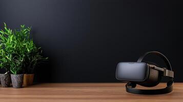 A black virtual reality headset sits on a wooden table next to a potted plant photo