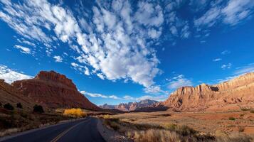 A road in the desert with clouds in the sky photo