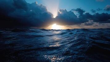 The sun shines through the clouds over the ocean photo