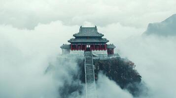 A chinese temple is surrounded by clouds photo
