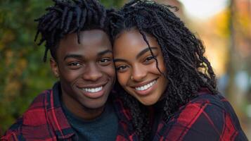 A young couple smiling and posing for the camera photo