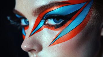 A woman with a colorful face paint and blue eyes photo