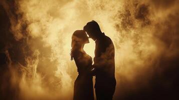 Silhouette of a couple kissing in the smoke photo