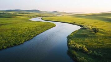 A river runs through a green field photo