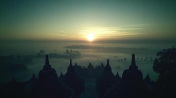The sun rises over the foggy landscape of bagan, myanmar photo