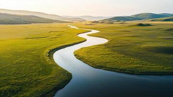 A river flowing through a grassy field photo