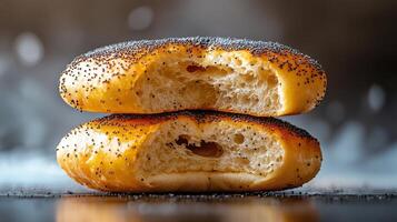 Two donuts with holes in them, one of which is missing a piece photo