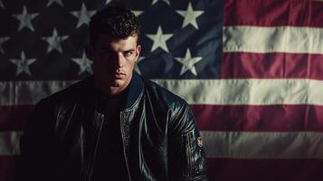 A man in a leather jacket standing in front of an american flag photo