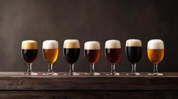 Six different types of beer in glasses on a wooden table photo