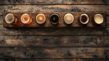 A row of beer glasses on a wooden table photo