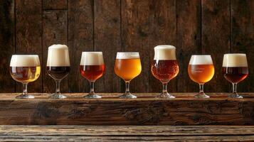 A row of beer glasses lined up on a wooden table photo