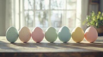 A row of colorful Easter eggs are sitting on a wooden table photo