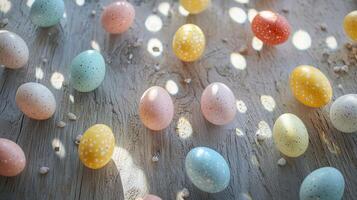 A bunch of Easter eggs are scattered on a wooden table photo