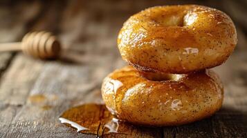 Two donuts sitting on top of a wooden table photo