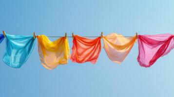 Colorful cloths hanging on a clothesline photo