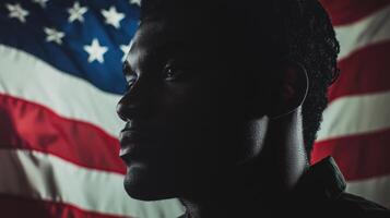 A strong male silhouette stands against a large American flag, embodying resilience and pride. The composition highlights patriotic themes and evokes deep emotions photo