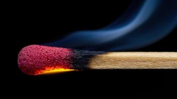 A matchstick with a red tip and black background photo