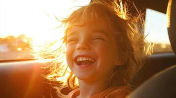 A young girl smiles while sitting in the car photo