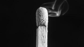A matchstick with smoke coming out of it photo