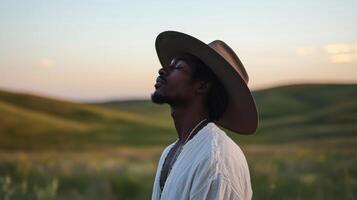 A man wearing a hat in a field photo