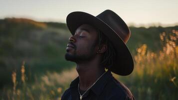 A man wearing a hat in a field photo