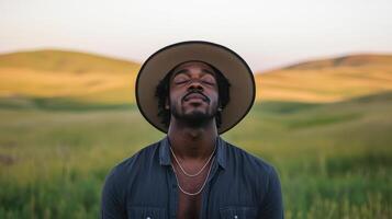 A man with a hat in a field photo