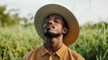 A man wearing a hat in a field photo
