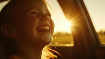 A young girl smiles as she sits in the car photo