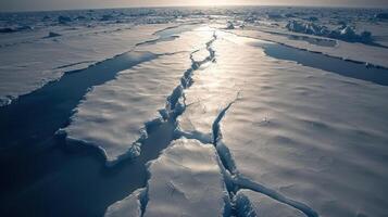 The sun is shining on a large crack in the ice photo