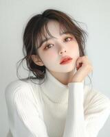 Portrait of a young woman with soft makeup and a white turtleneck sweater. Beautiful, elegant, and serene. photo