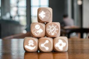Wooden blocks with synergy icons symbolizing teamwork, innovation, and connectivity in a collaborative environment. photo