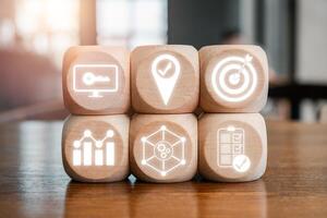 Wooden blocks with icons representing the Objectives and Key Results concept for business strategy and goal setting. photo