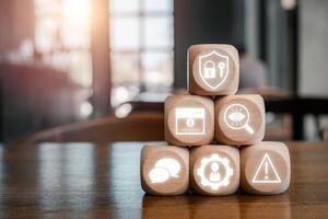 Wooden blocks with digital security icons representing social engineering concepts in a modern office environment. photo