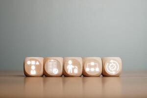 Wooden blocks depicting the 5S methodology icons for improving workplace organization and efficiency. photo