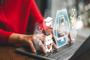 Conceptual image of a learning management system with digital icons representing online education and e-learning on a laptop. photo