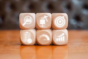 Wooden blocks with business intelligence icons representing data analysis, strategic planning, and performance metrics. photo