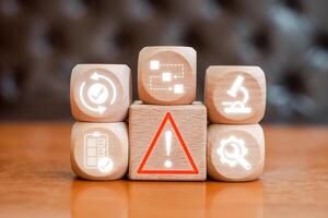 Illustration of incident management with symbols on wooden blocks, representing business solutions and risk control strategies. photo