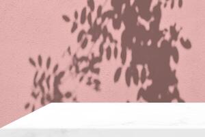 Empty White Marble Table Corner with Leaves Shadow on Pink Wall Background photo