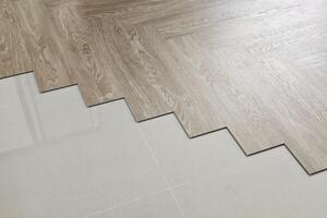 SPC Floor Being Installed in a Herringbone Pattern. photo