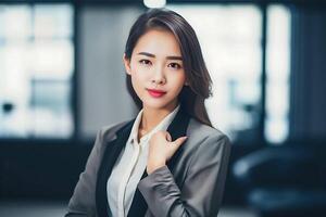 Smart working woman with a business suit is standing and posting in front of a blur office environment background. 127 photo